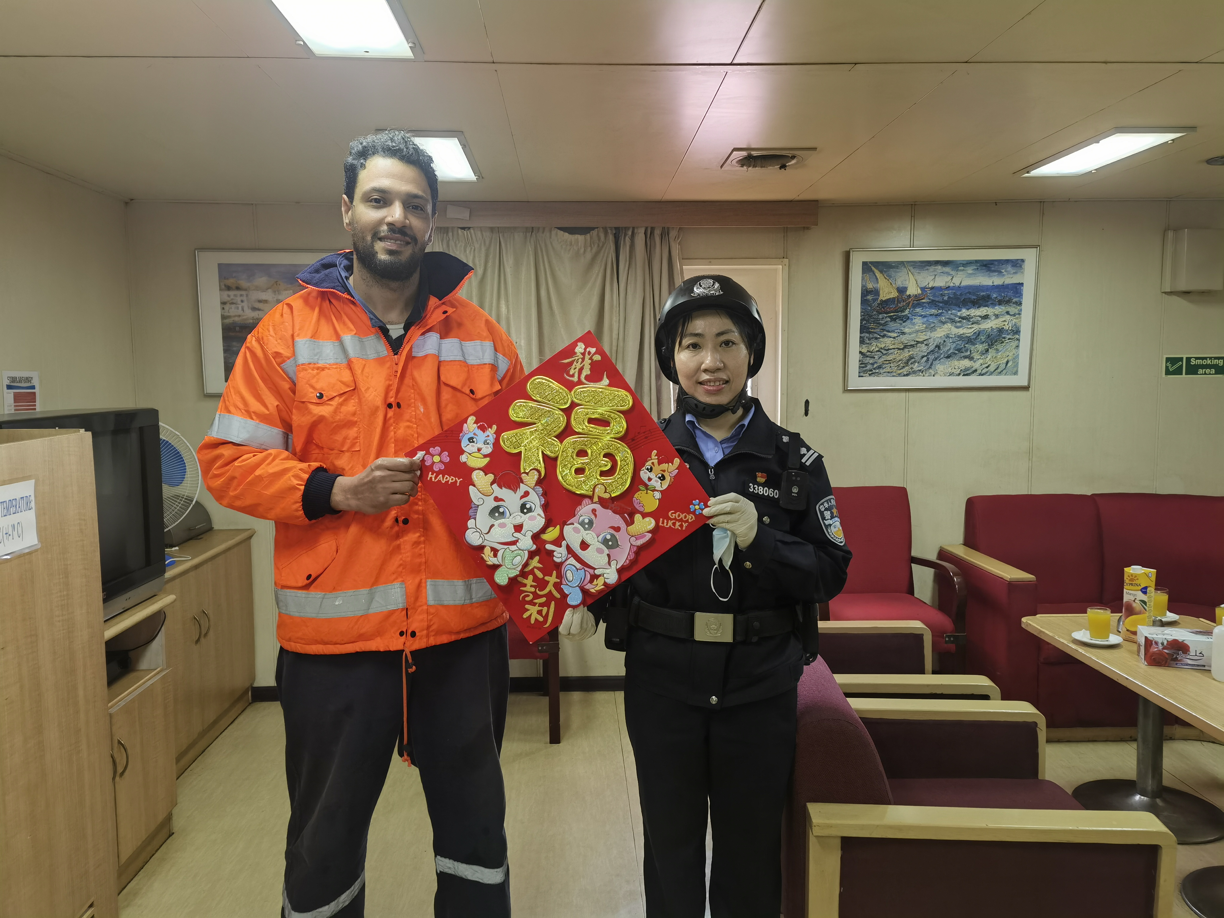 圖三為執(zhí)勤民警陳嬌外籍船舶為船員送祝福賀新春。.jpg